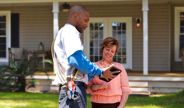 Field service worker getting a signature from a customer using the MobiWork field services software solution