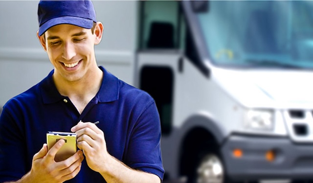 Delivery man standing in front of delivery truck using the MobiWork last mile delivery services software solution