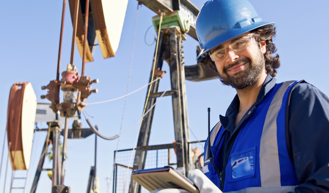 Technician working on a smartphone with the MobiWork oil and gas field services software solution