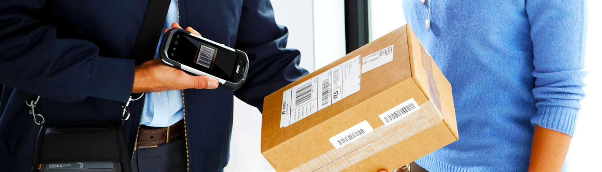 worker using last mile delivery software scans package before giving it to client