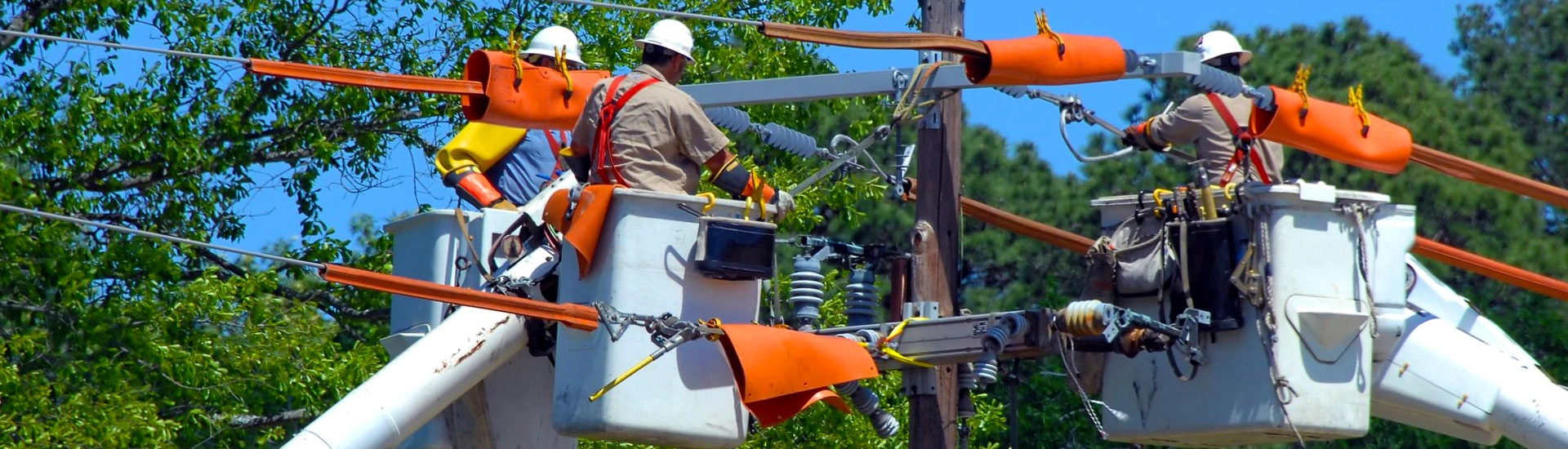 three men using utility field service software fix a utility pole